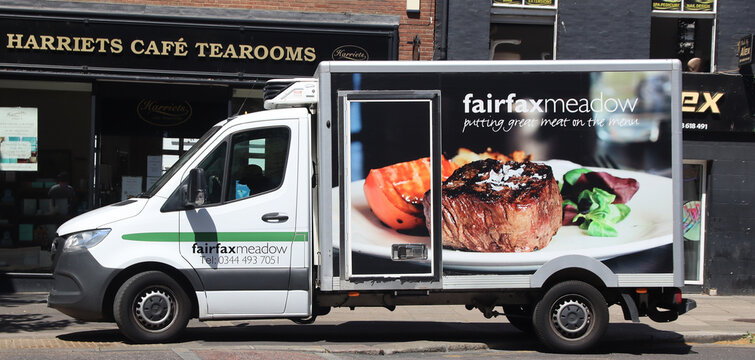 Norwich, United Kingdom - July 5, 2026: General street view in Norwich city centre Food delivery van advertising premium steak with advertisement fairfax meadow