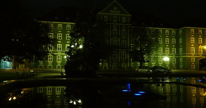 Pond Reflection and Szczecin City Hall at Night in Jasne Błonia - Night view of the pond at Jasne Błonia Square with reflections on the water and the illuminated Szczecin City Hall building 