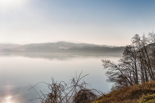 Landscape with a lake and mountains on the opposite shore. Sunny winter day.