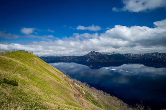 Stunning view of Lake Mashu with pristine blue waters and surrounding mountain peaks