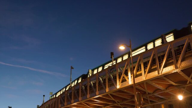 Paris Metro Train Passing Over Bir-Hakeim Steel Viaduct Bridge at Dusk