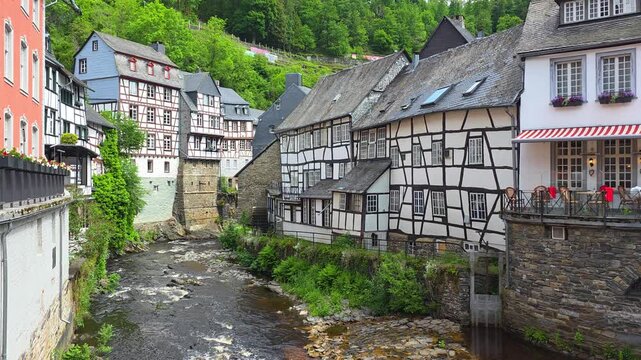 Idyllic town of Monschau in the Eifel region of western Germany. Riverside half timbered houses along a flowing river.