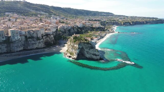 Tropea, Calabria, Italy. Aerial drone footage of Santa Maria dell&rsquo;Isola rock, old town cliffs, beaches and turquoise Tyrrhenian Sea along the Costa degli Dei.