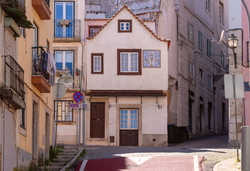 Naklejka premium Traditional Historic House on Narrow Street in Alfama District Lisbon Portugal