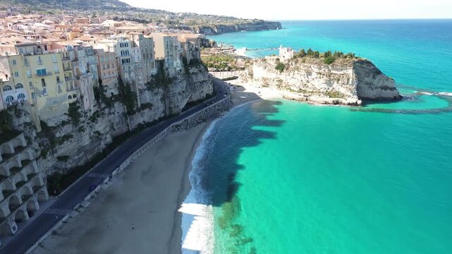 Tropea, Calabria, Italy. Aerial drone footage of the cliffside old town, Santa Maria dell&rsquo;Isola, sandy beach and turquoise Tyrrhenian Sea on the Costa degli Dei.