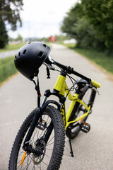 Fototapeta premium Modern Bicycle with Protective Helmet on Handlebar