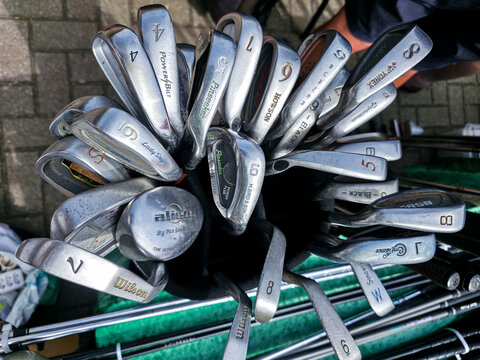 XALO, SPAIN - JUNE 20, 2026.View from above showing golf bag filled with used iron clubs from different brands before a round of golf