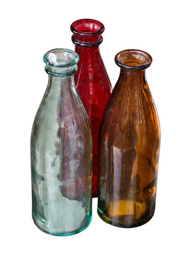 Three empty glass bottles in different colors stand together against a white background. These bottles can be used for various purposes in home decor or crafts.
