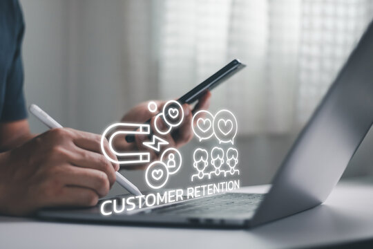 Business professional using smartphone and laptop with customer retention icon, customer loyalty, CRM strategy, digital marketing, audience engagement, relationship management, business growth.