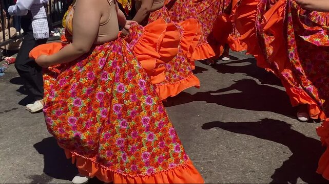 A group of Colombian dancers perform a traditional dance in a cultural parade on a street during the San Juan and San Pedro Festival in Neiva, Huila, Colombia. Concept of Colombian culture