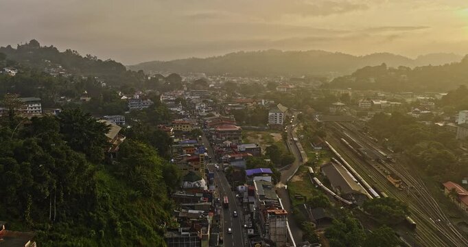 Kandy Sri Lanka Aerial v26 drone flyover city center along A1 road capturing railway station, Deiyannewela hillside and golden sunrise mountainous landscape views - Shot with Mavic 3 Cine - April 2023
