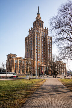 Riga, Latvia - March 7, 2026: The Latvian Academy of Sciences, a Stalinist socialist-classicism skyscraper nicknamed Stalin's Birthday Cake, rising above bare winter trees