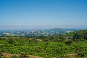 Fototapeta premium View from Bodmin Moor edge overlooking rolling green fields and distant hills