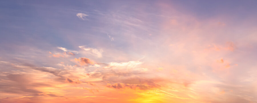 Beautiful sunset sky background with soft pastel pink purple clouds and bright golden sun glow for panoramic travel mockup design