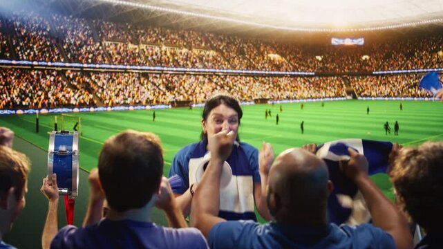 Energetic woman shouts through megaphone in stadium, leading football fans during match, showing female supporter galvanizing soccer crowd doing loud chants in sports arena for fan culture content.