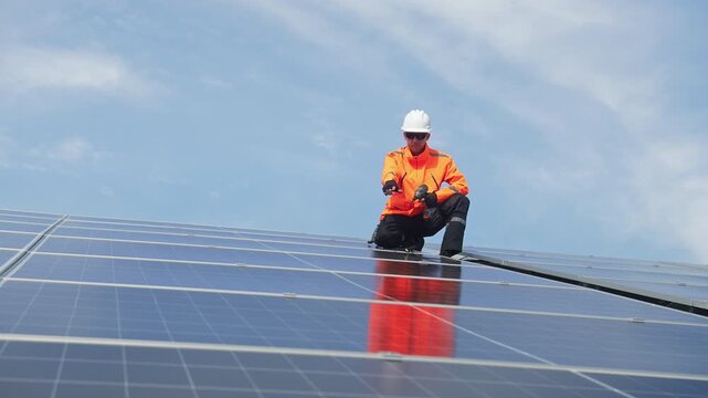 Technician installing rooftop solar panels for green energy, supporting renewable energy, clean power, sustainable technology and solar infrastructure.