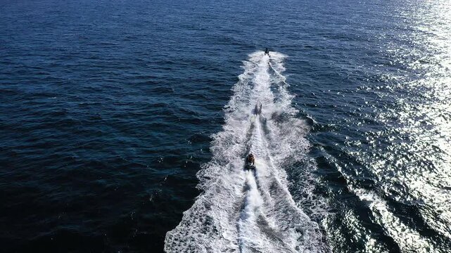 Aerial view of a group of wave runners sailing fast, in the coast of Torrevieja, Spain.