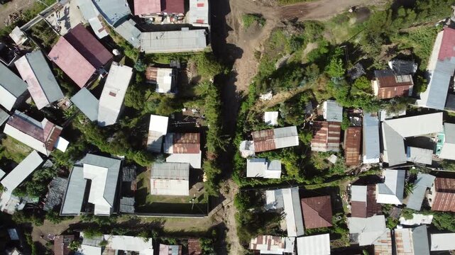 Aerial downward shot of the densely populated city of Dessie, Ethiopia with metal roofs and dirt roads.