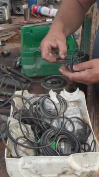 Mechanic selecting rubber o rings for engine repair
