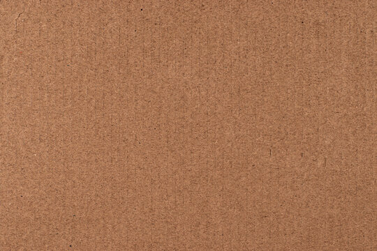 Vertical ribbed brown cardboard texture background with straight lines
