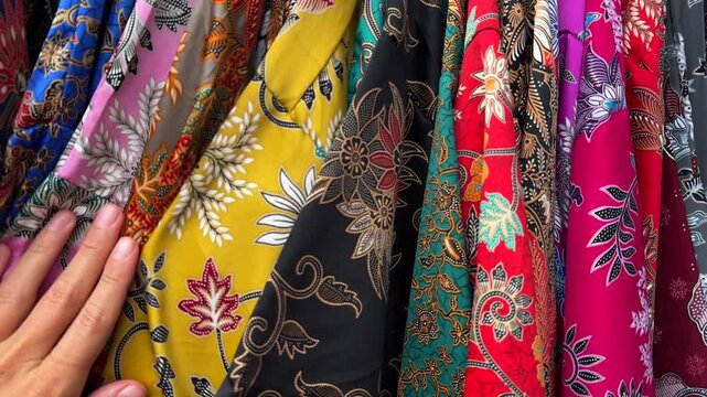 Shopping. Person explores a rich array of clothes. Vibrant clothes concept. Colors and patterns inspire creativity while shoppers enjoy the vibrant atmosphere