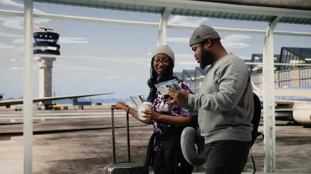 Friends walking in airport terminal traveling together to foreign countries, looking at plane ticket, African American travel friends reading boarding pass flight information, for mobile travel tech.