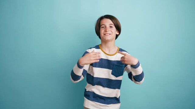 Happy enthusiastic kid wearing a striped shirt gesturing and talking directly to the camera. Expressive boy having a conversation