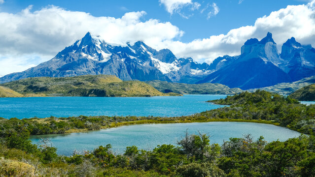 Torres del Paine National Park, Patagonia, Chile &mdash; a stunning view of turquoise lakes, rugged mountains, and snow-capped peaks under a bright blue sky