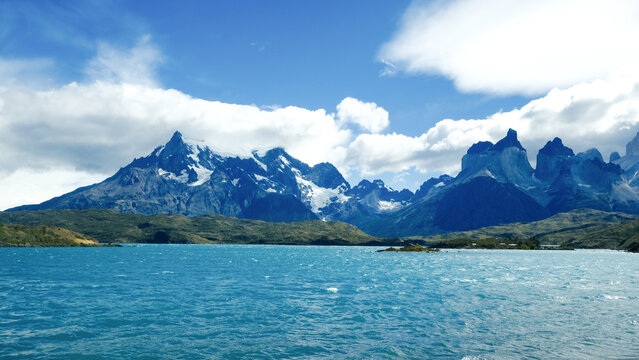 Torres del Paine National Park, Patagonia, Chile &mdash; a stunning view of turquoise lakes, rugged mountains, and snow-capped peaks under a bright blue sky