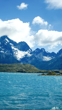 Torres del Paine National Park, Patagonia, Chile &mdash; a stunning view of turquoise lakes, rugged mountains, and snow-capped peaks under a bright blue sky