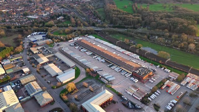 Massive industrial distribution park managing international cargo and final-mile courier logistics, aerial shot.