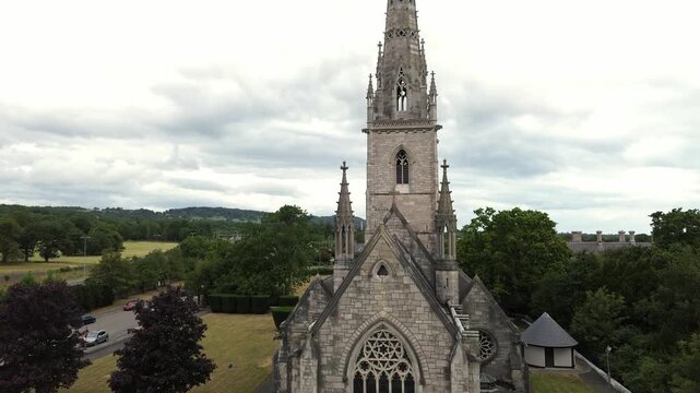 Rising up St Margaret's marble church neo gothic spire steeple tower in Bodelwyddan, Wales