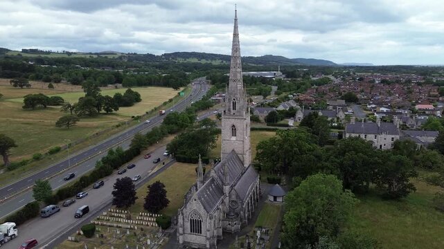 St Margaret's Marble church aerial view across neo gothic spire in Rhyl parish and A55 motorway