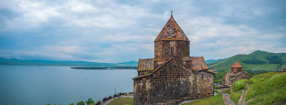Panoramic Sevanavank monastery near lake Sevan with cloudy sky copy space