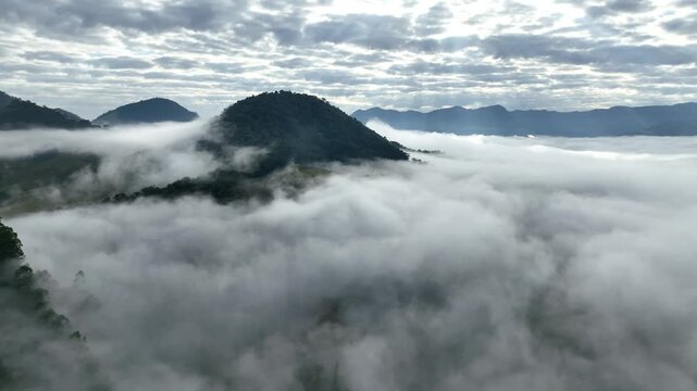 S&atilde;o Bento do Sapuca&iacute; at dawn, with a blanket of clouds over the valley. Aerial view. Flying above the clouds. Serra da Mantiqueira, Vale do Paraiba. Atlantic Forest