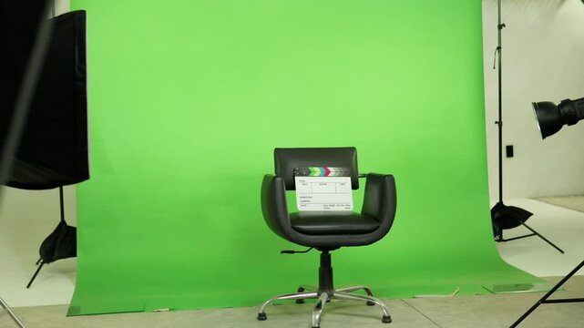 Empty director chair in a film studio with green screen