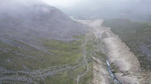Drone view of valley in rainy fog day in mount Kula Kangri, Shannan, Tibet, China. 4K real time footage travel concept.