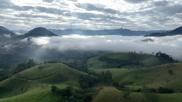 S&atilde;o Bento do Sapuca&iacute; at dawn, with a blanket of clouds over the valley. Aerial view. Flying above the clouds. Serra da Mantiqueira, Vale do Paraiba. Atlantic Forest