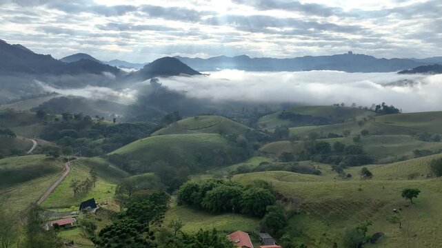 S&atilde;o Bento do Sapuca&iacute; at dawn, with a blanket of clouds over the valley. Aerial view. Flying above the clouds. Serra da Mantiqueira, Vale do Paraiba. Atlantic Forest