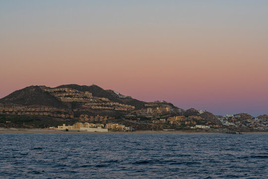 resorts along pacific coast of cabo san lucas mexico at southernmost tip of baja california peninsula during twilight