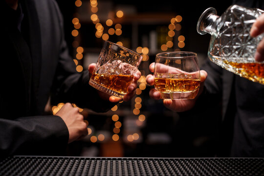 Businessmen Toasting Glasses of Premium Whiskey in a Luxury Bar