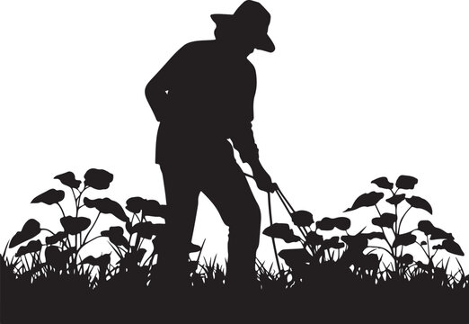 Silhouette of a farmer, weeding with tool, in a field