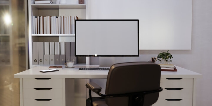 Home office desk setup with white computer screen mockup