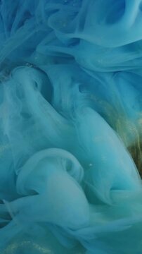 Vertical video. Smoke background. Cloud ink. Blur blue yellow neon color ethereal vapor liquid chemical exhaust soaring on dark black abstraction.