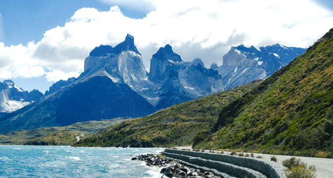A scenic mountain road through the breathtaking landscape of Torres del Paine National Park, with turquoise waters and rugged peaks in Patagonia, Chile