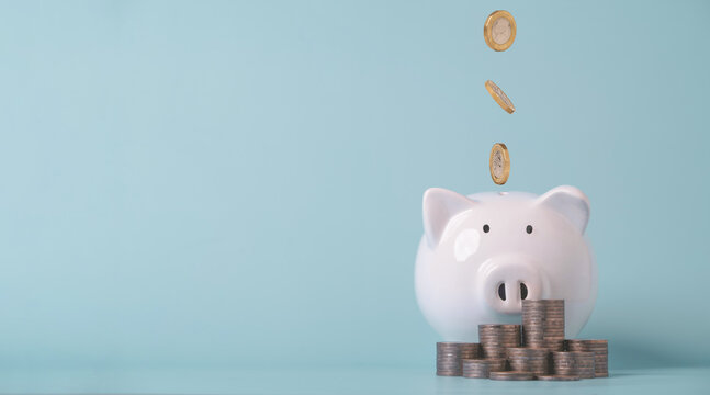 Piggy bank with falling coins symbolizes saving money, personal finance, wealth growth, financial planning, investment strategy, budgeting, emergency fund and long-term financial security.
