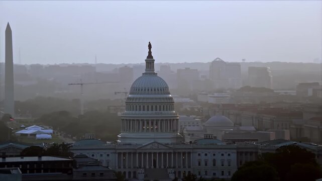 United States Capitol Building at Sunrise with Washington Monument in Morning Haze