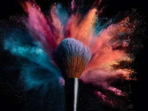 Explosion of colorful makeup powder around a brush.