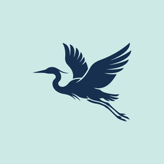 Fototapeta premium A dark blue heron silhouette flies in the sky