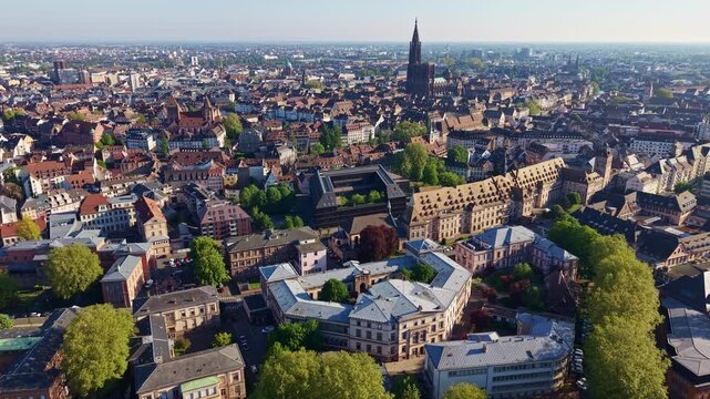 Cath&eacute;drale Notre-Dame de Strasbourg and &Eacute;glise Saint-Thomas rise above the UNESCO Grande &Icirc;le in Strasbourg, Bas-Rhin, Grand Est, Alsace, France, revealing the historic skyline, drone forward flight.